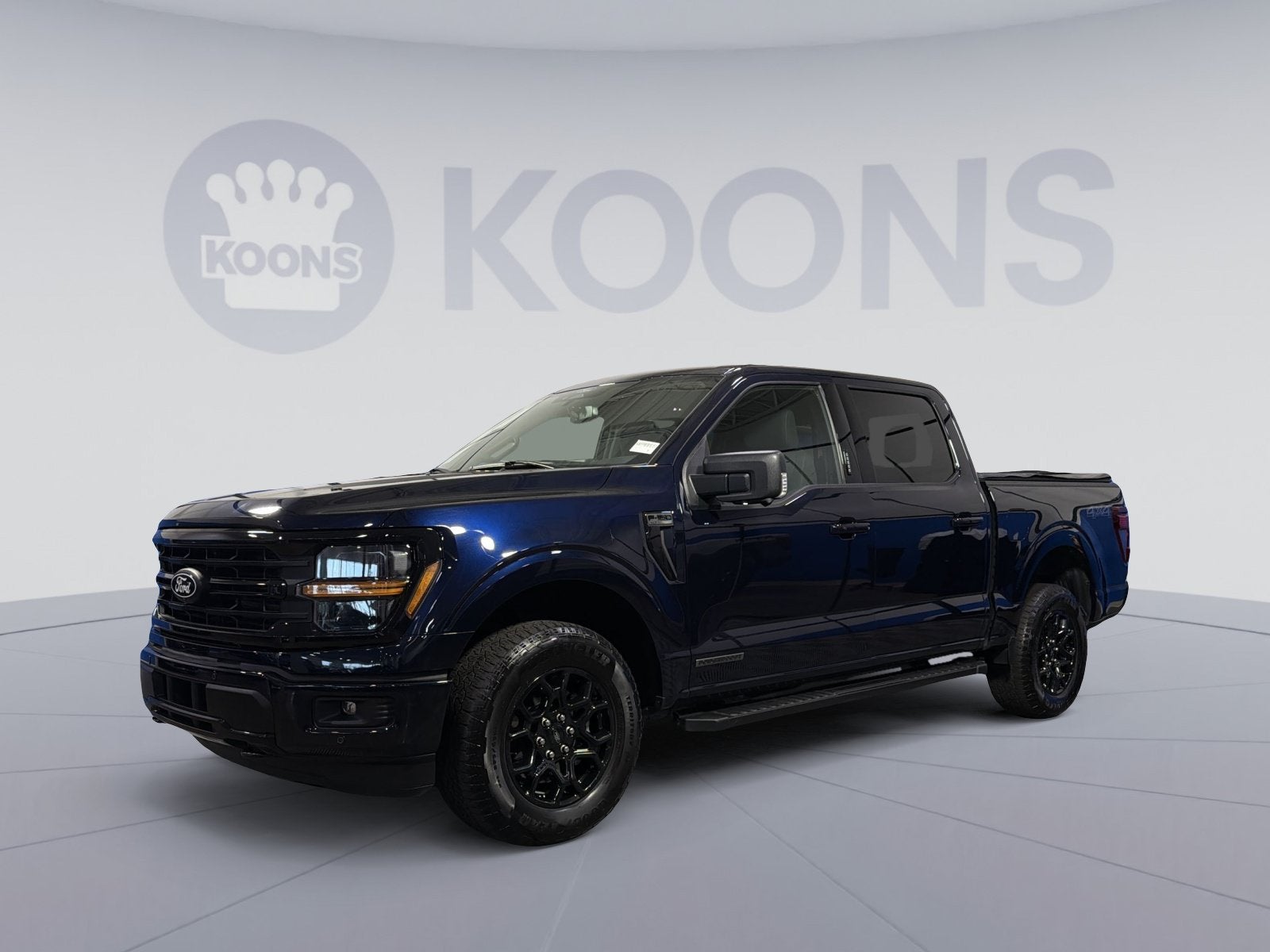 2024 Ford F-150 XLT in Blue Metallic — front three-quarter view